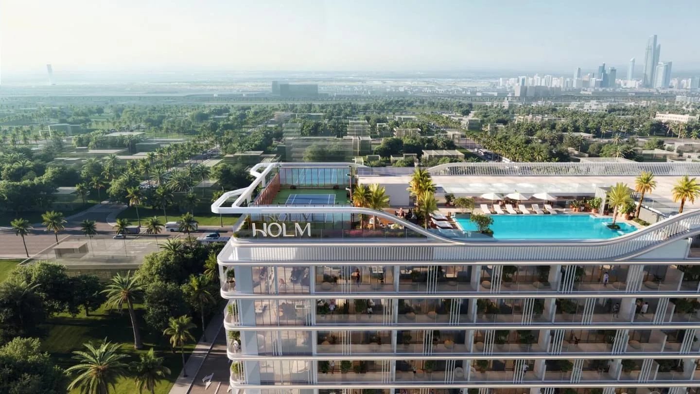 Aerial view of the Linea by Holm development showing the rooftop pool deck and surrounding greenery.
