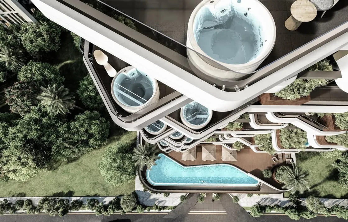 An aerial view of the podium amenity deck, curved pools set among landscaped gardens