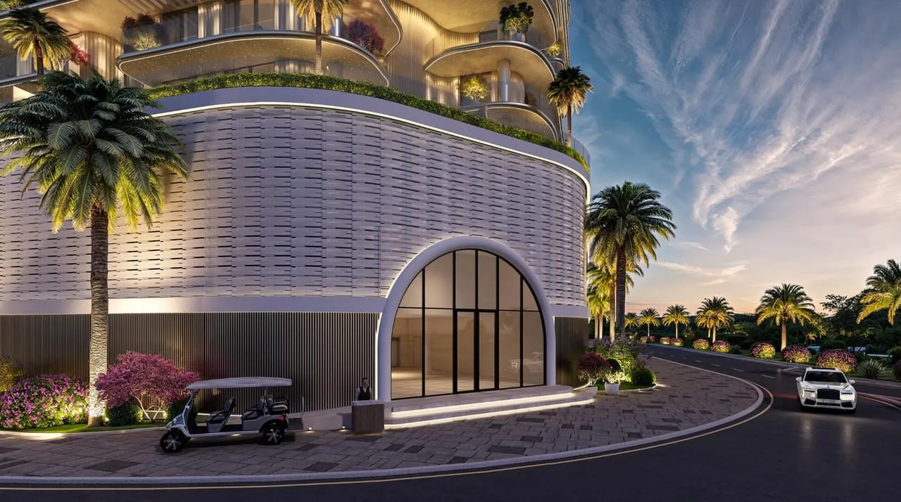 The arrival court at dusk, a car waiting under the tall arched entrance between two palm trees