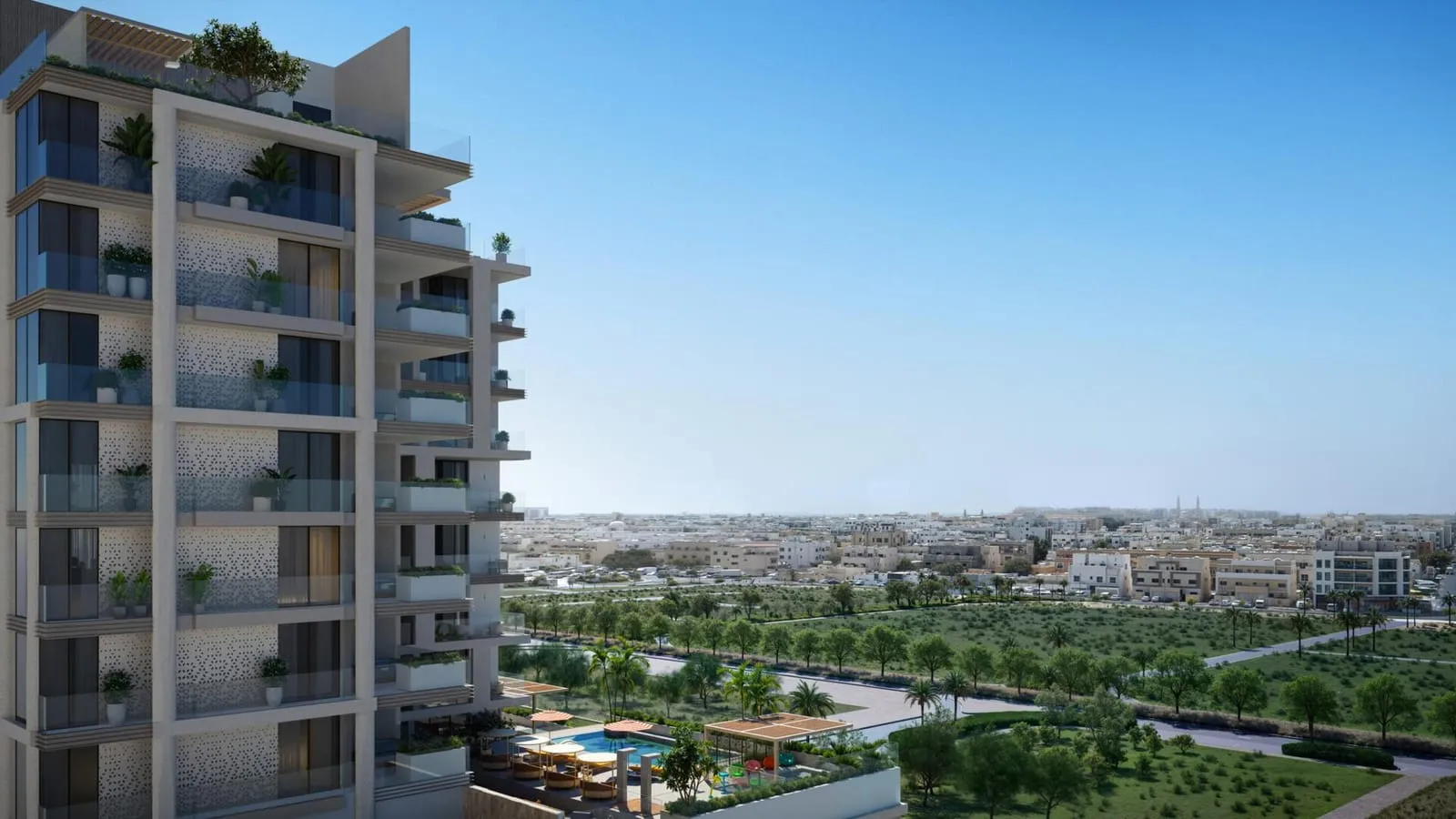 The planted balcony face seen from the air, low-rise rooftops and a green corridor running out to the horizon