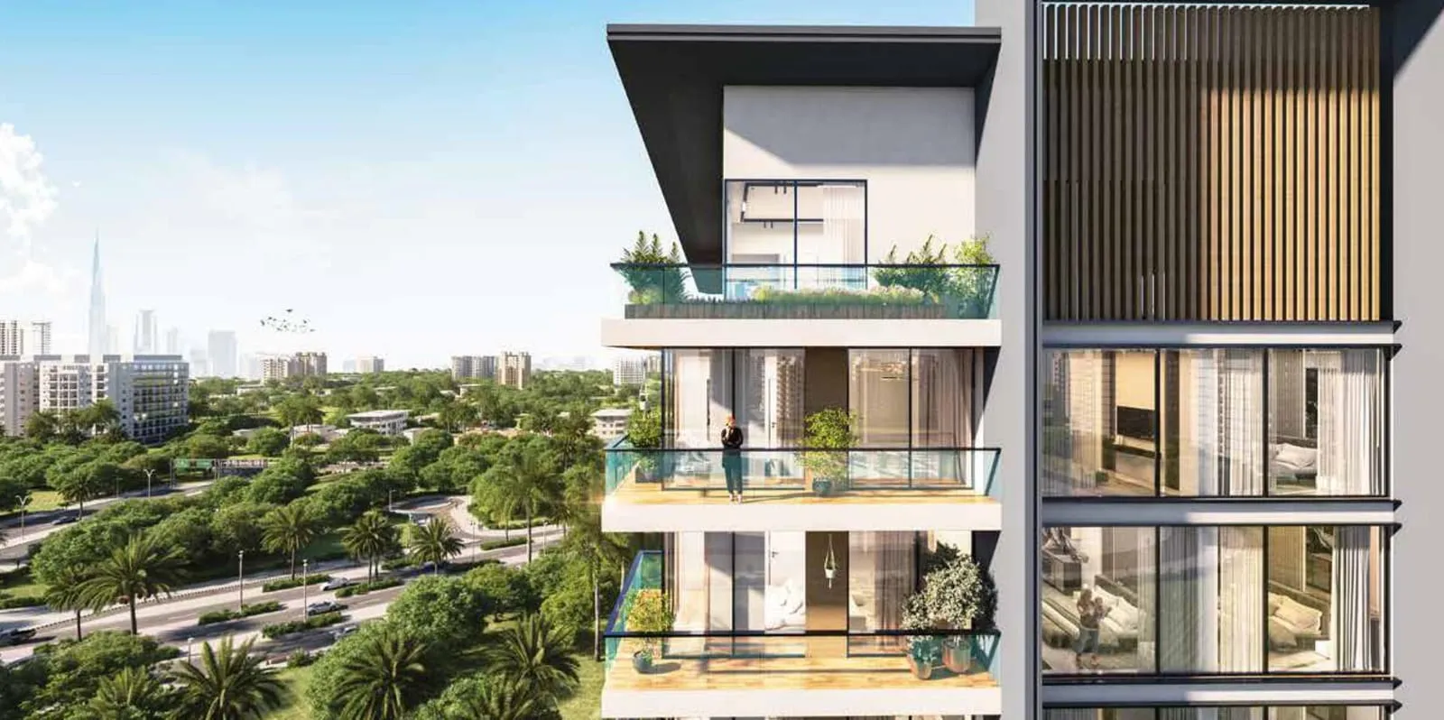 Stacked upper-floor balconies planted with greenery, looking out over the treetops towards the city skyline