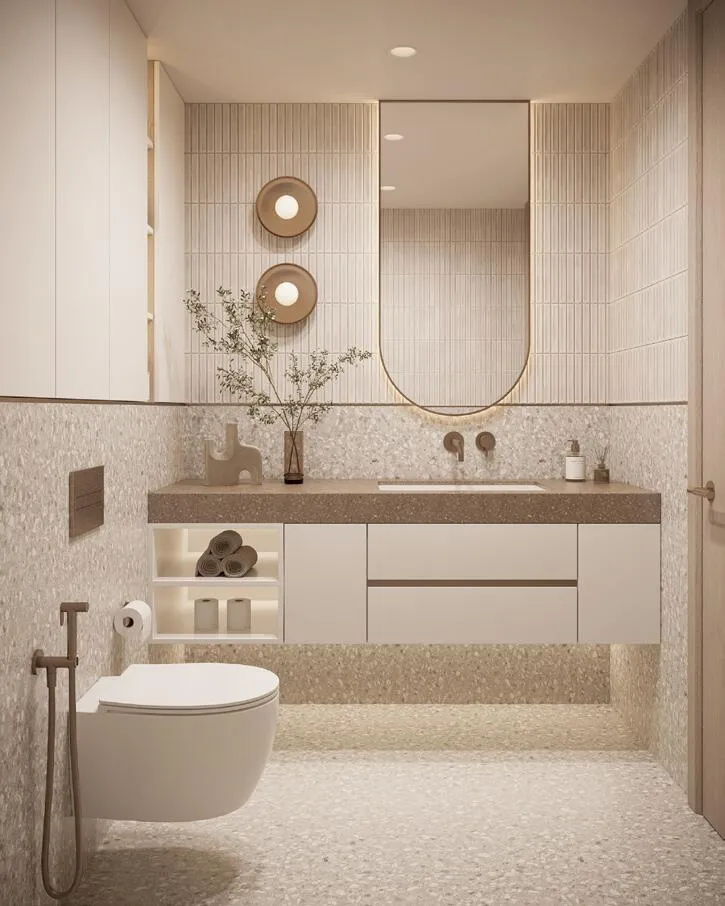 A terrazzo-tiled bathroom with a freestanding tub and a handheld shower spray