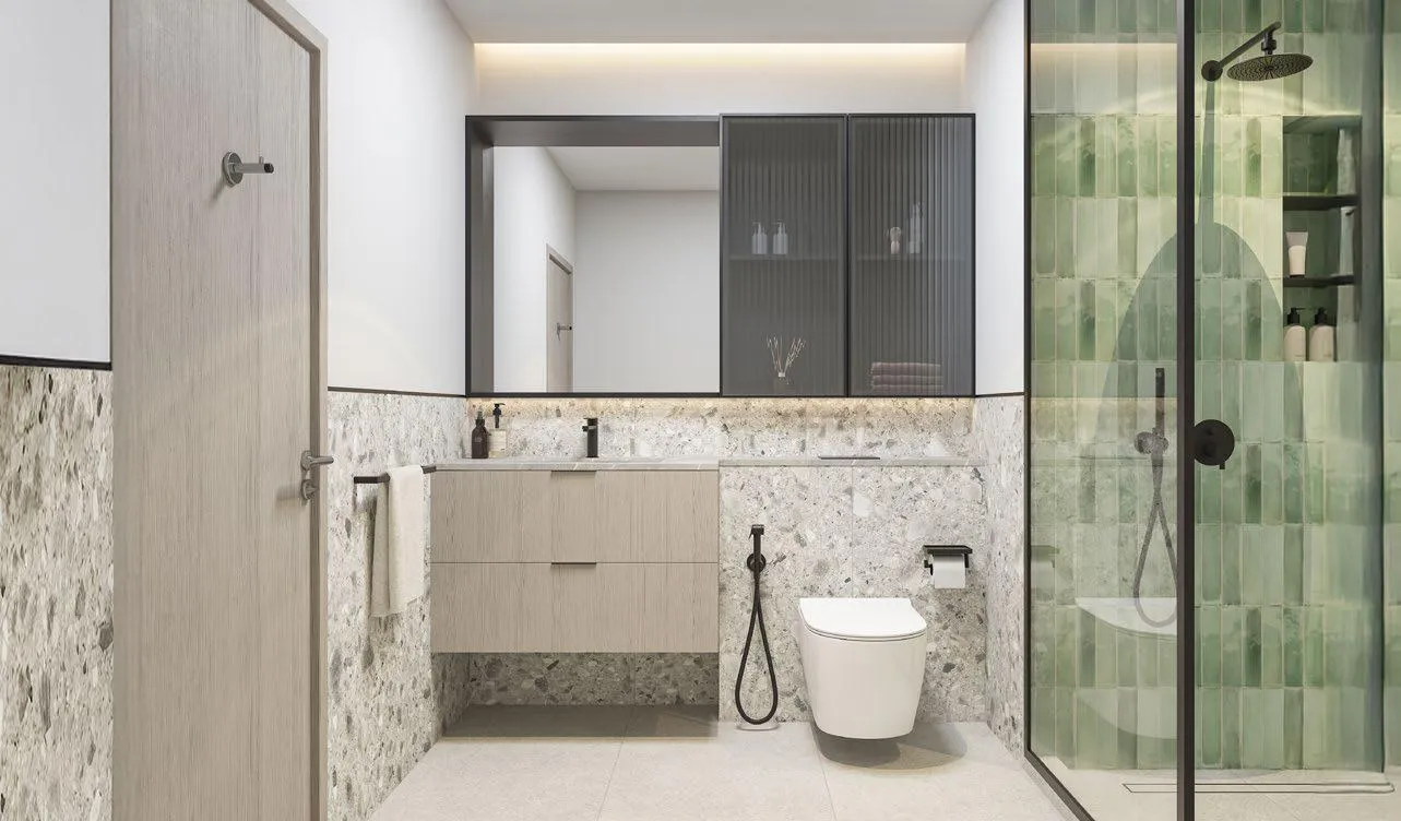 A bathroom with a stone vanity under a mirror, and a walk-in shower behind glass tiled in green
