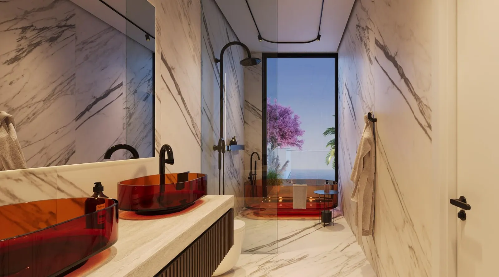 A marble bathroom with a red vessel basin on a long ledge, a glazed shower and a window onto a flowering tree