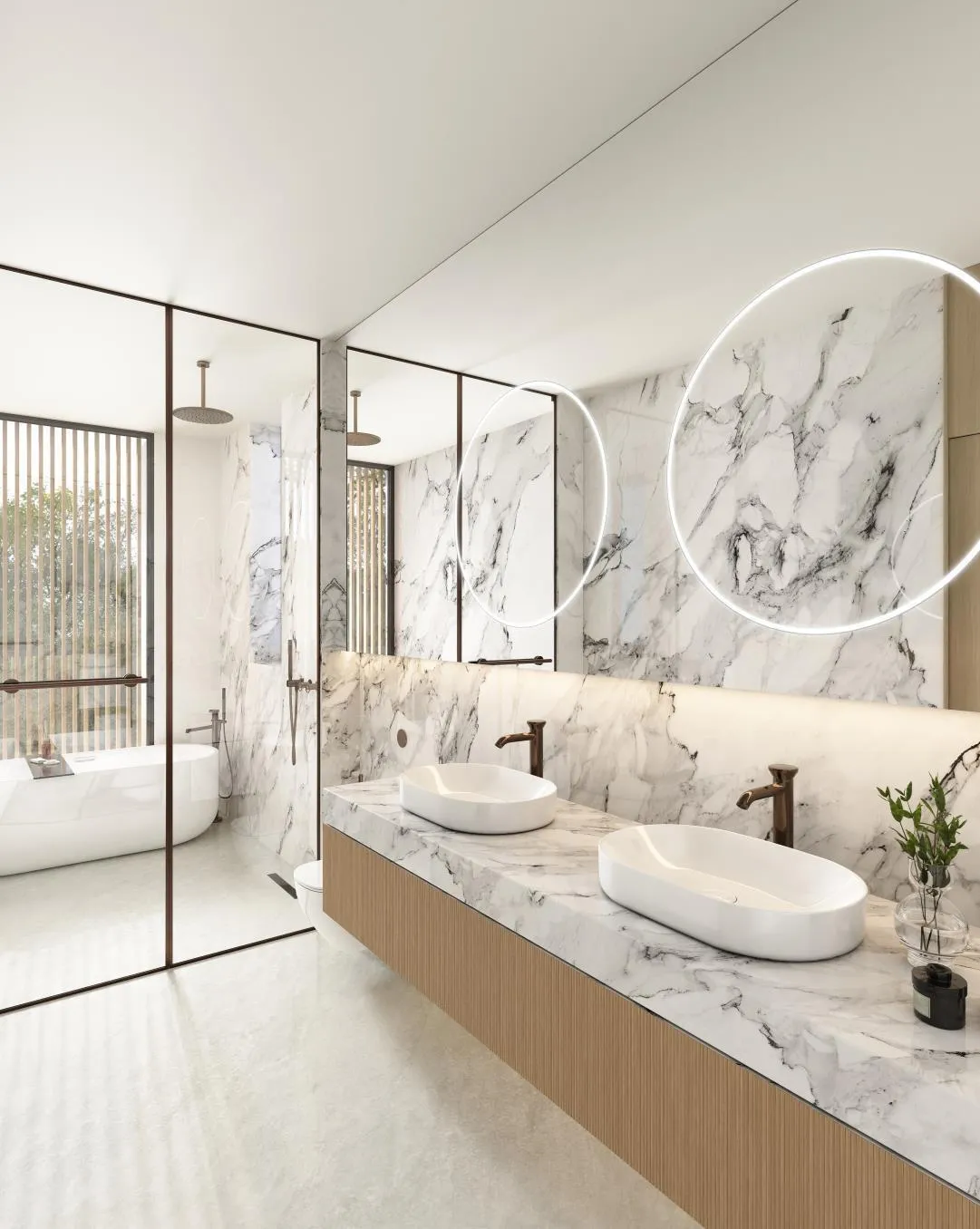 A marble Karl Lagerfeld bathroom with a round mirror above the basins and a freestanding bath