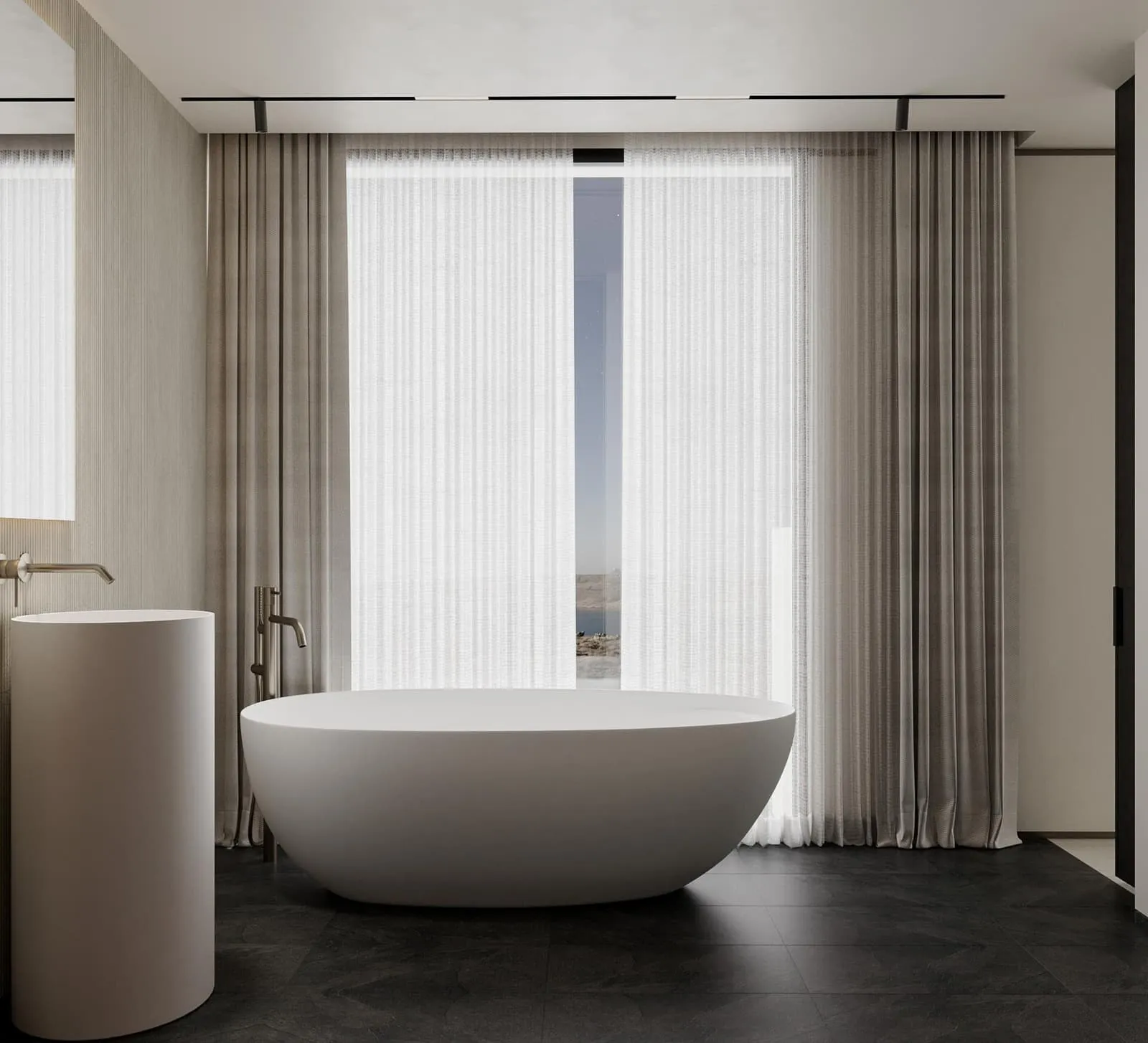 A bathroom with a glazed walk-in shower and dark stone tiling beside a curtained window