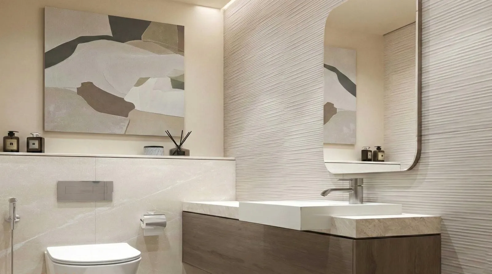 A bathroom in pale stone with a backlit mirror above the vanity and an abstract print on the wall