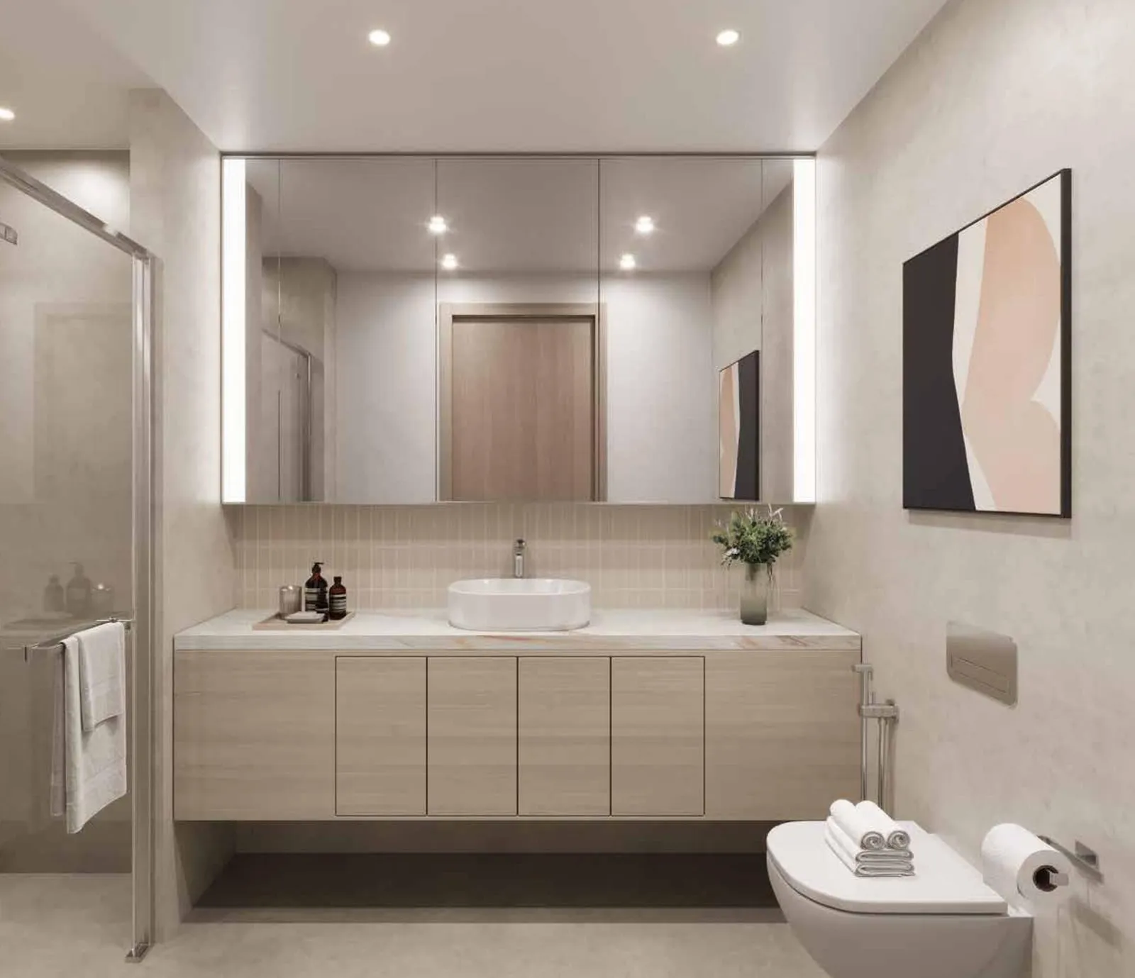 A bathroom with a countertop basin, a full-width backlit mirror and pale timber cabinetry