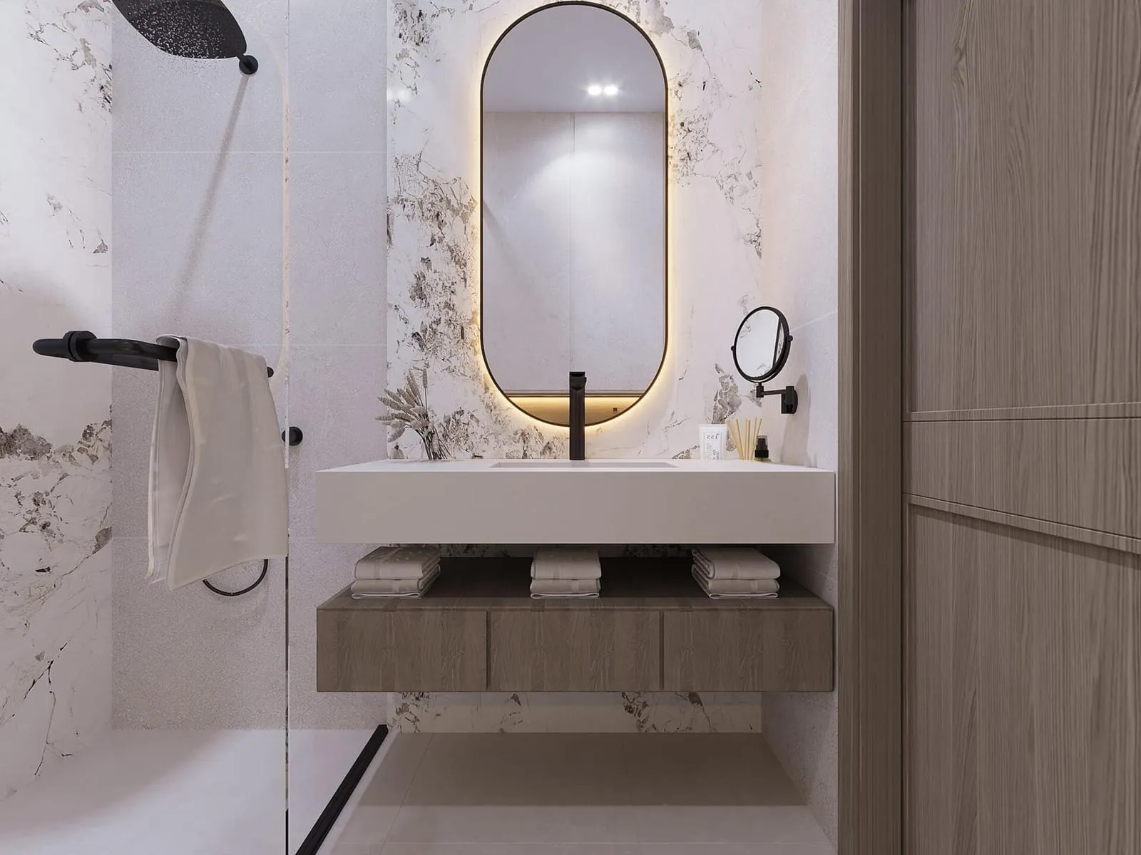 Bathroom vanity with a backlit mirror and marble countertop