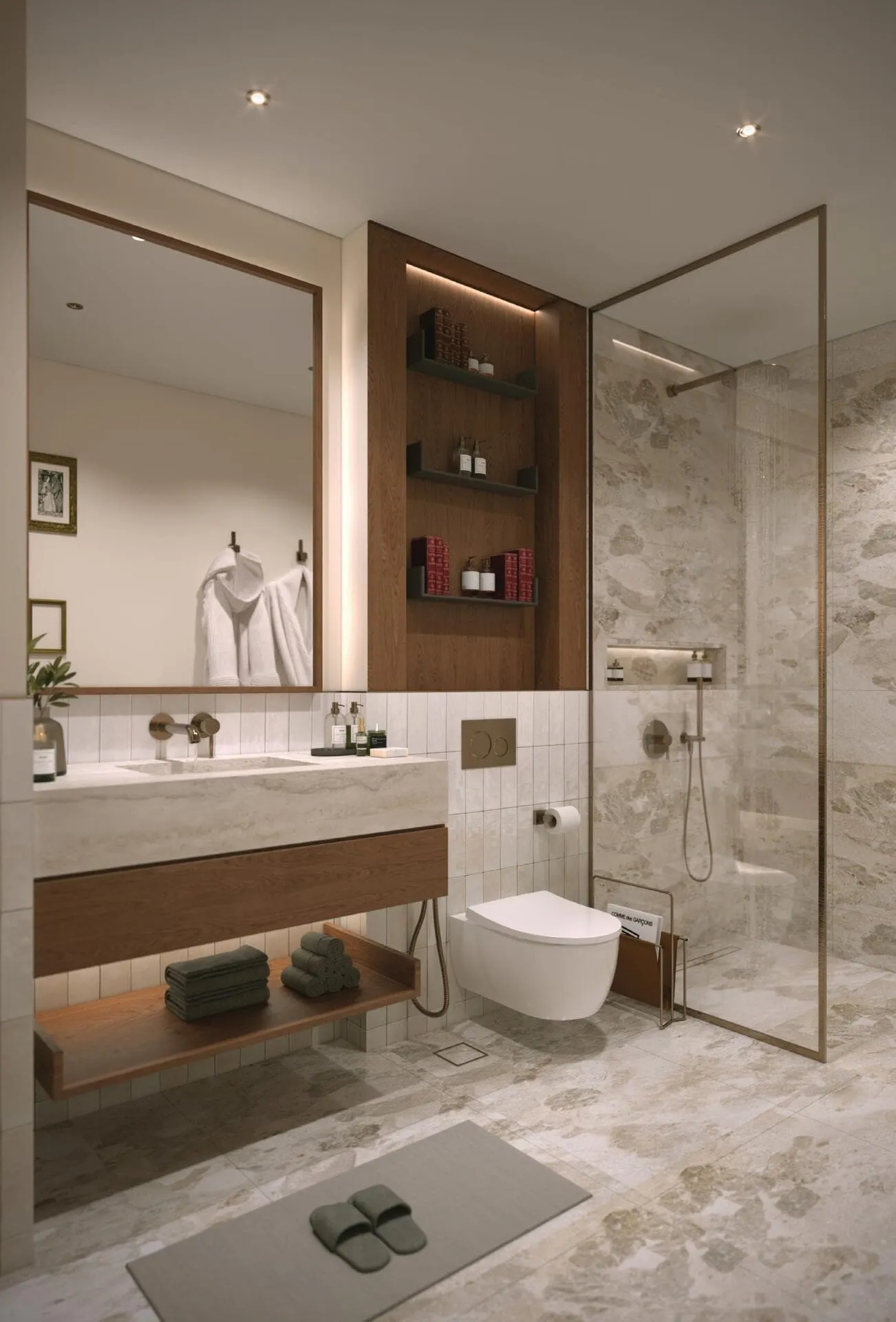 A bathroom with a stone vanity, a framed mirror and a walk-in shower behind a glass screen