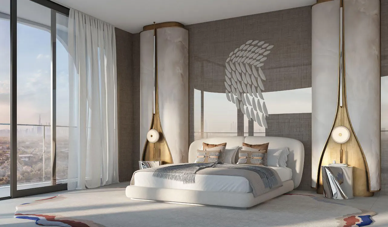 A bedroom behind sheer curtains, brass pendant lamps hanging either side of the bed under a sculpted wall relief