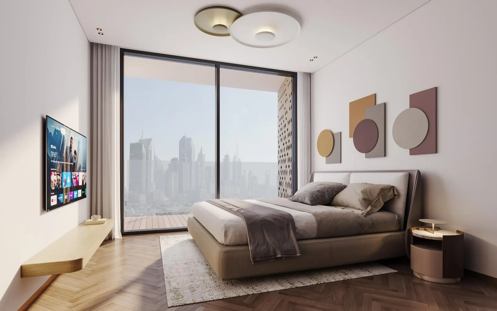 A bedroom with an upholstered bed, a screen on the opposite wall and the city framed in the window beyond