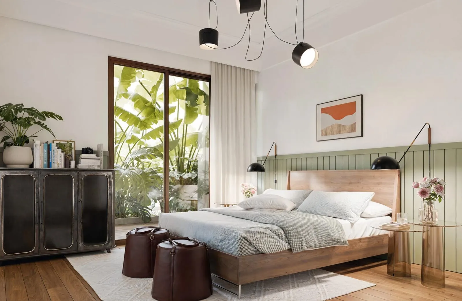 A bedroom finished with soft green cabinetry and natural light from a garden-facing window.
