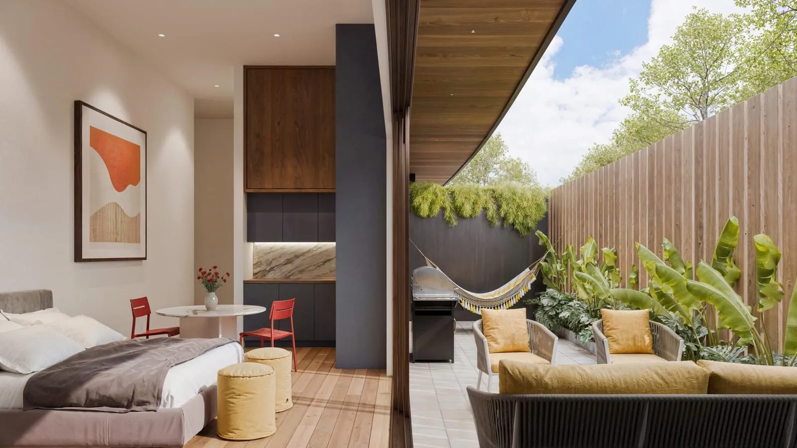 An open bedroom flowing onto a furnished outdoor lounge framed by greenery.