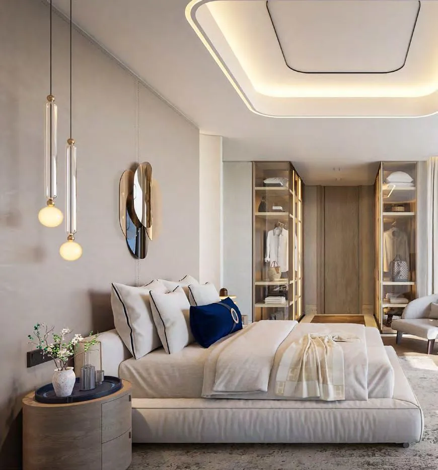 A bedroom with a round mirror above the console and pendants either side
