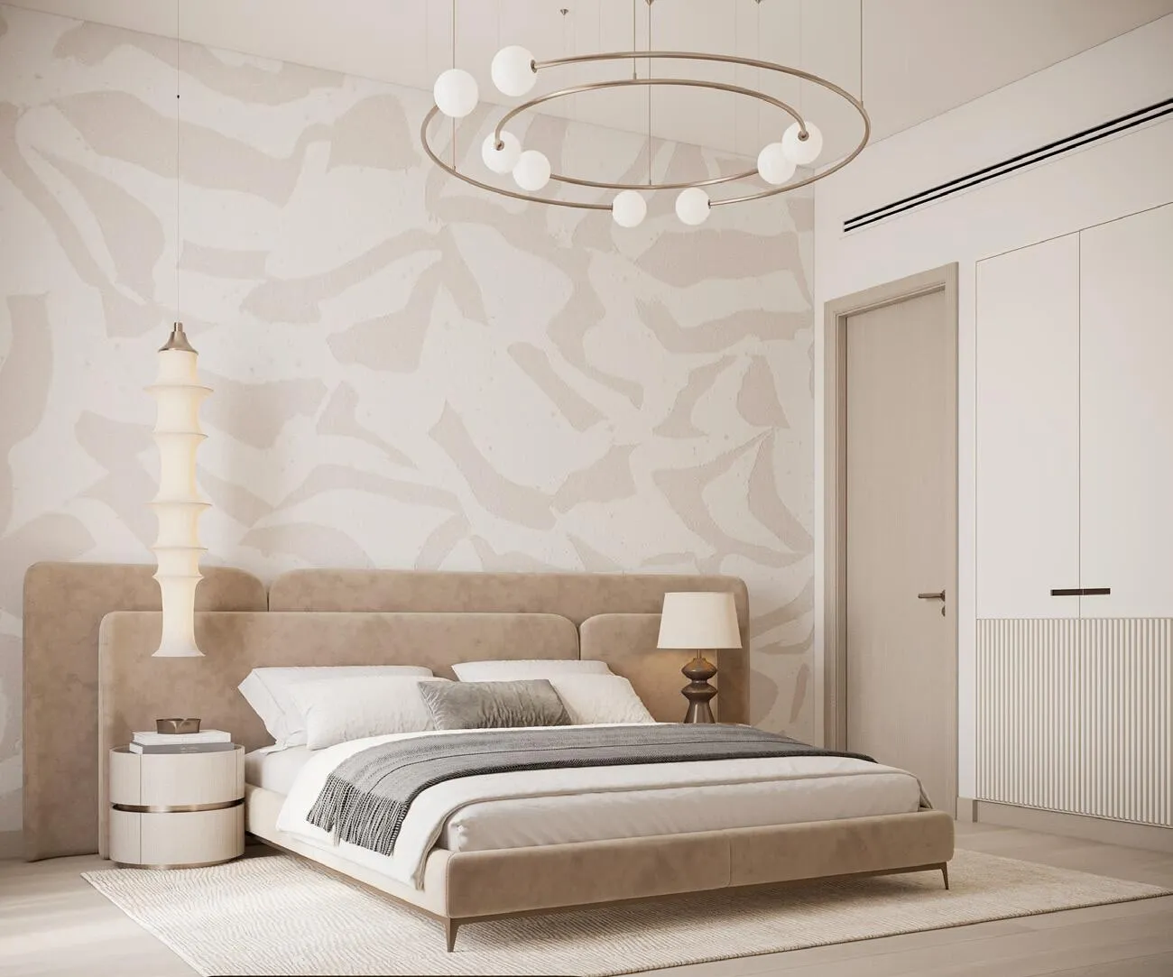 A bedroom lit by a circular pendant fixture, with abstract art above the headboard