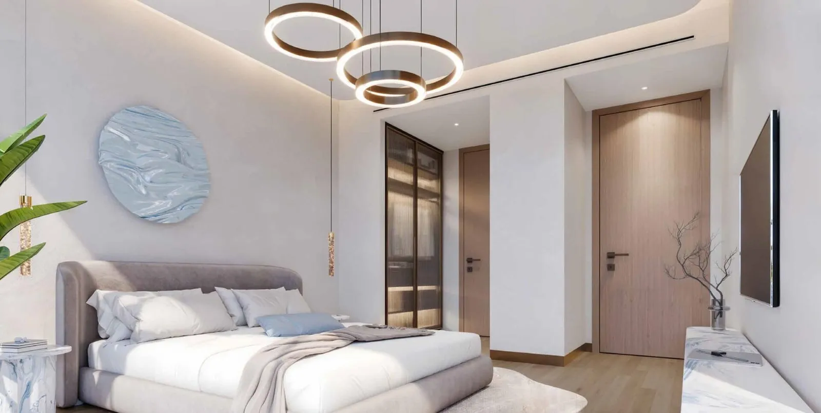 A bedroom in pale tones, a ring pendant over the bed, a round artwork above the headboard and a screen opposite