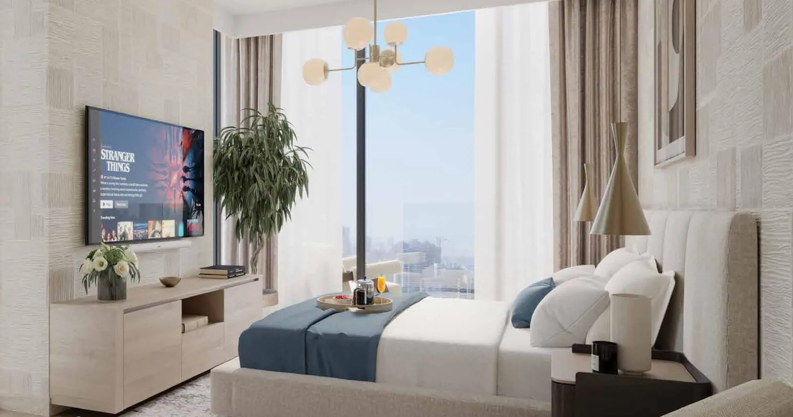 A bedroom in navy linen with a wall-mounted television above a low console, opening to a city view