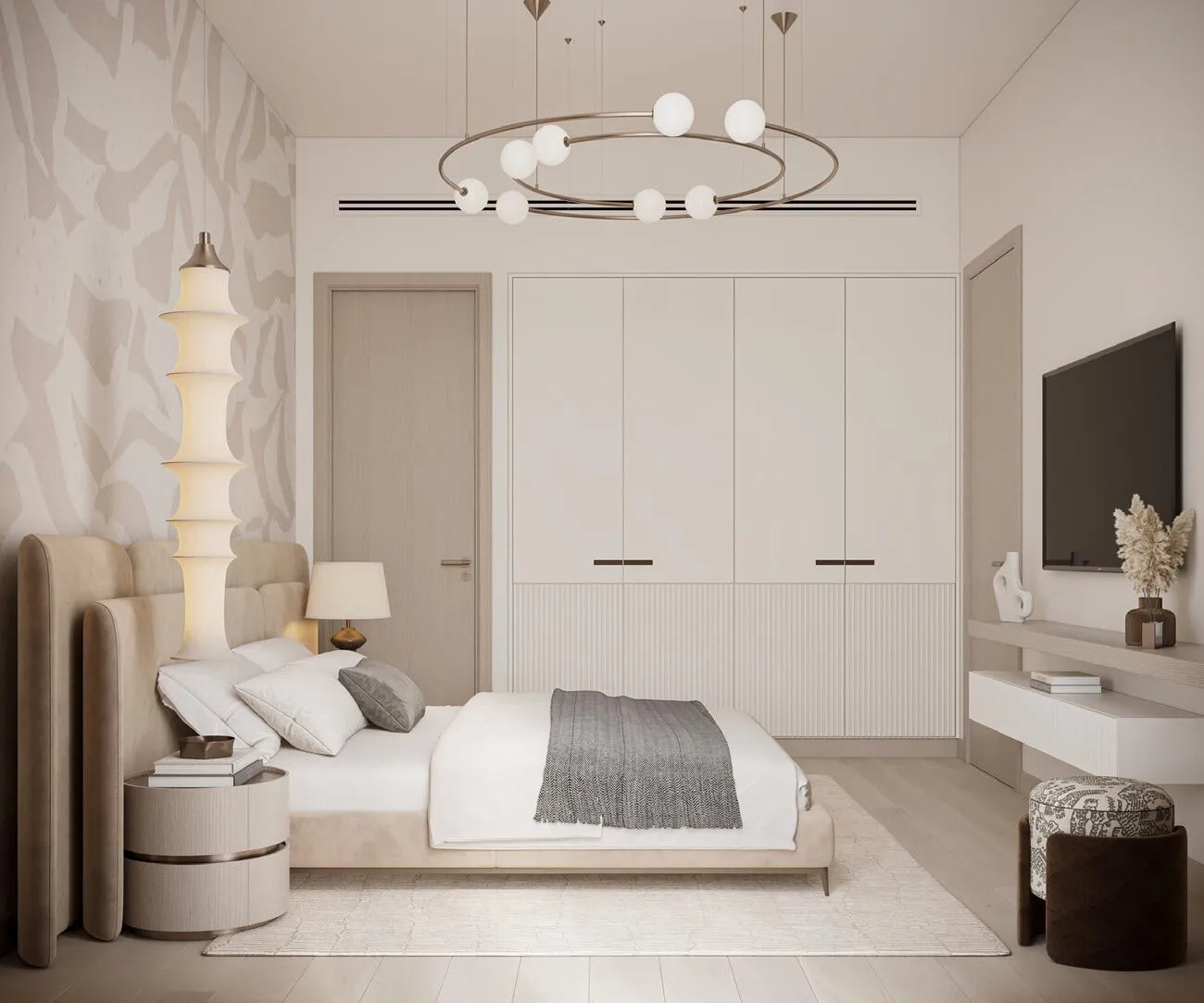 A bedroom with the bed facing a wall-mounted television and patterned wallpaper behind the headboard