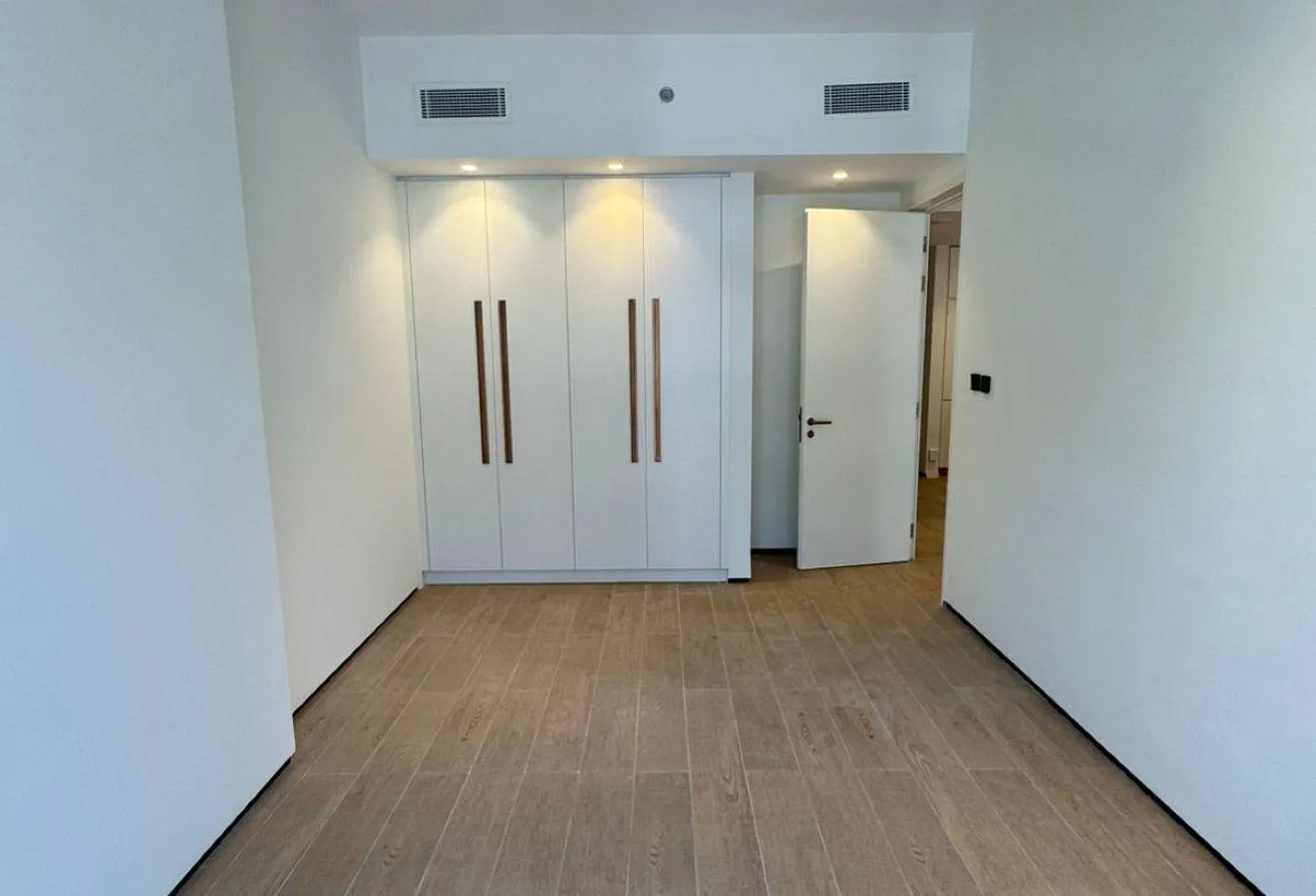 Photo of a room with a wall of built-in wardrobes