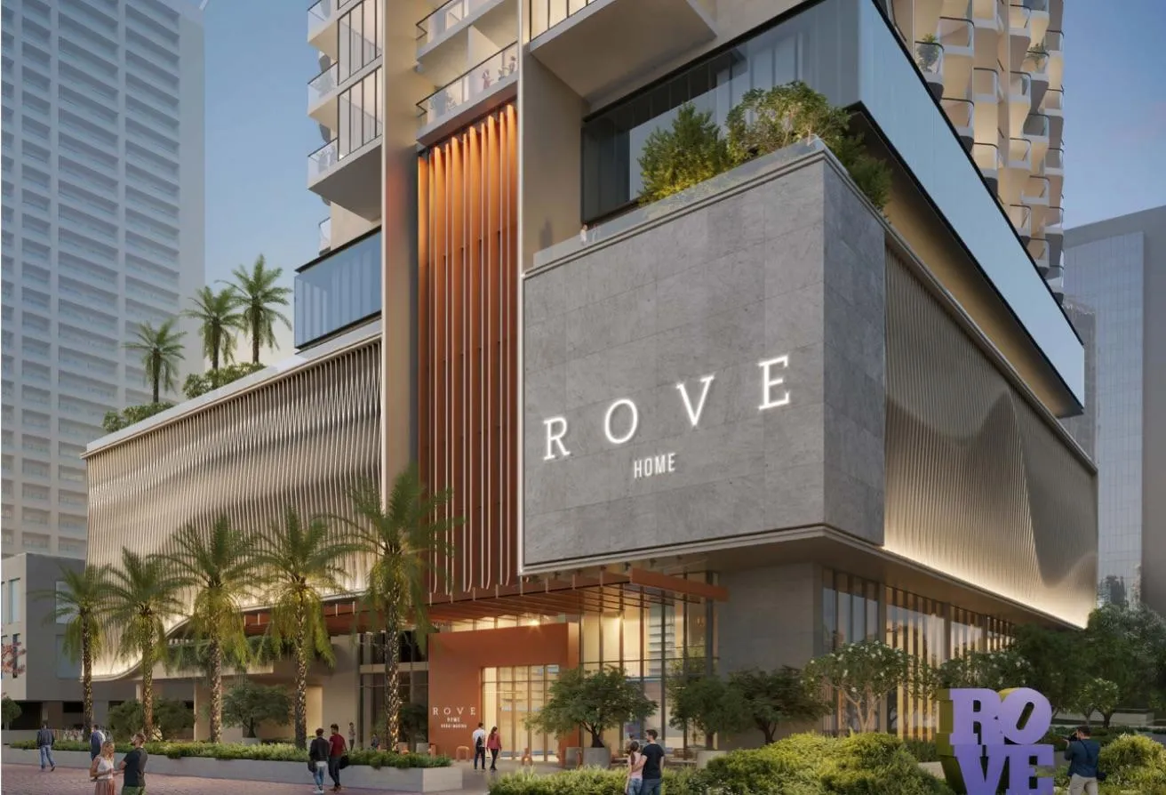Render of Rove Home Dubai Marina from the street, its podium carrying the Rove Home name between palm trees