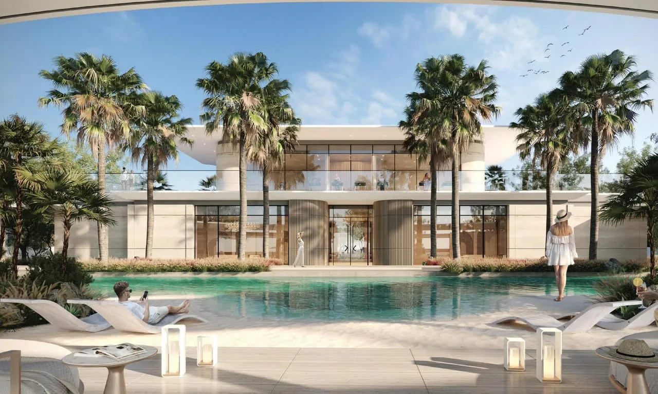 The clubhouse pool at Karl Lagerfeld Villas, palms and sun loungers around the water