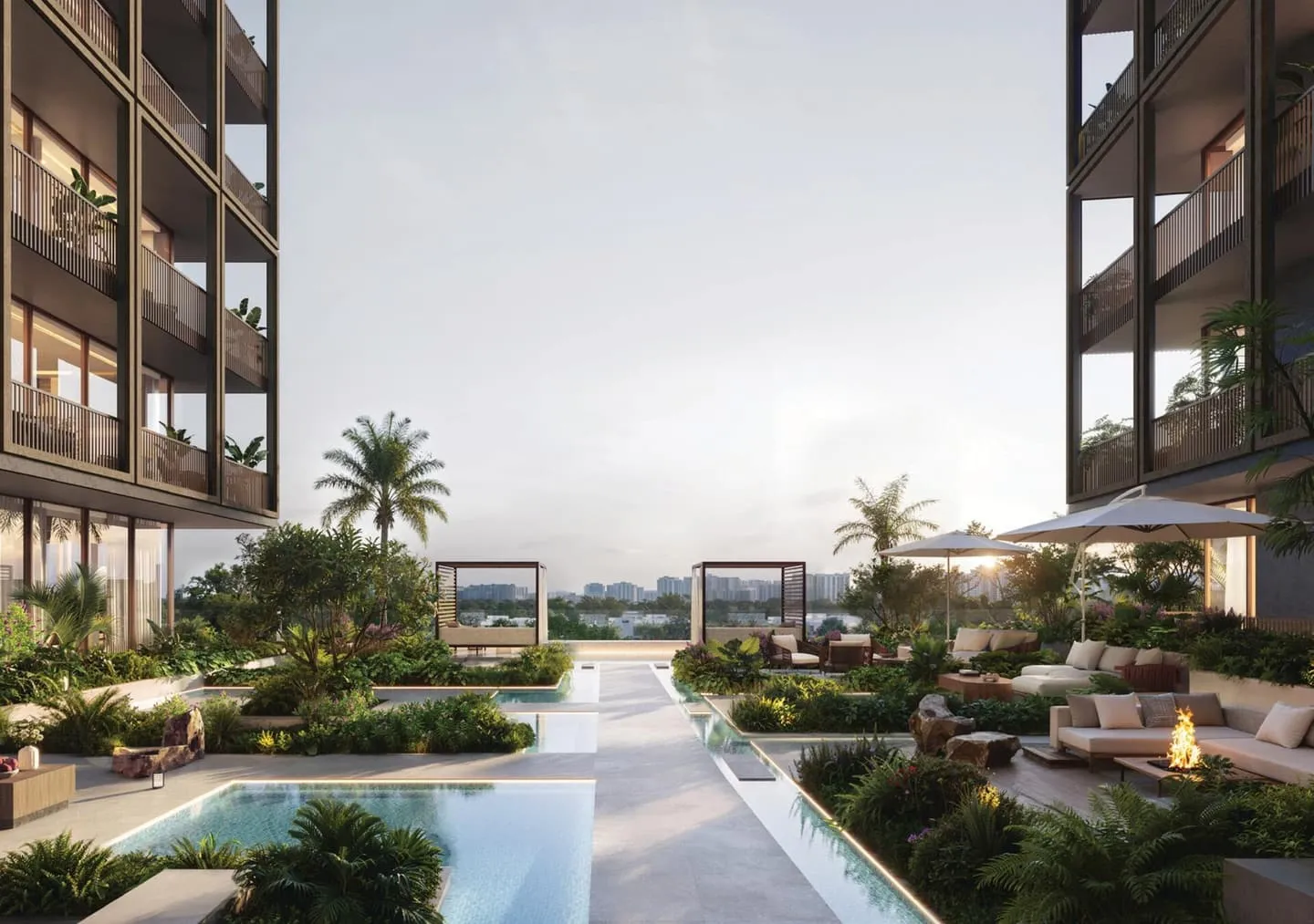 The pool and garden between the two wings, cabanas at the far end and a fire bowl among the seating