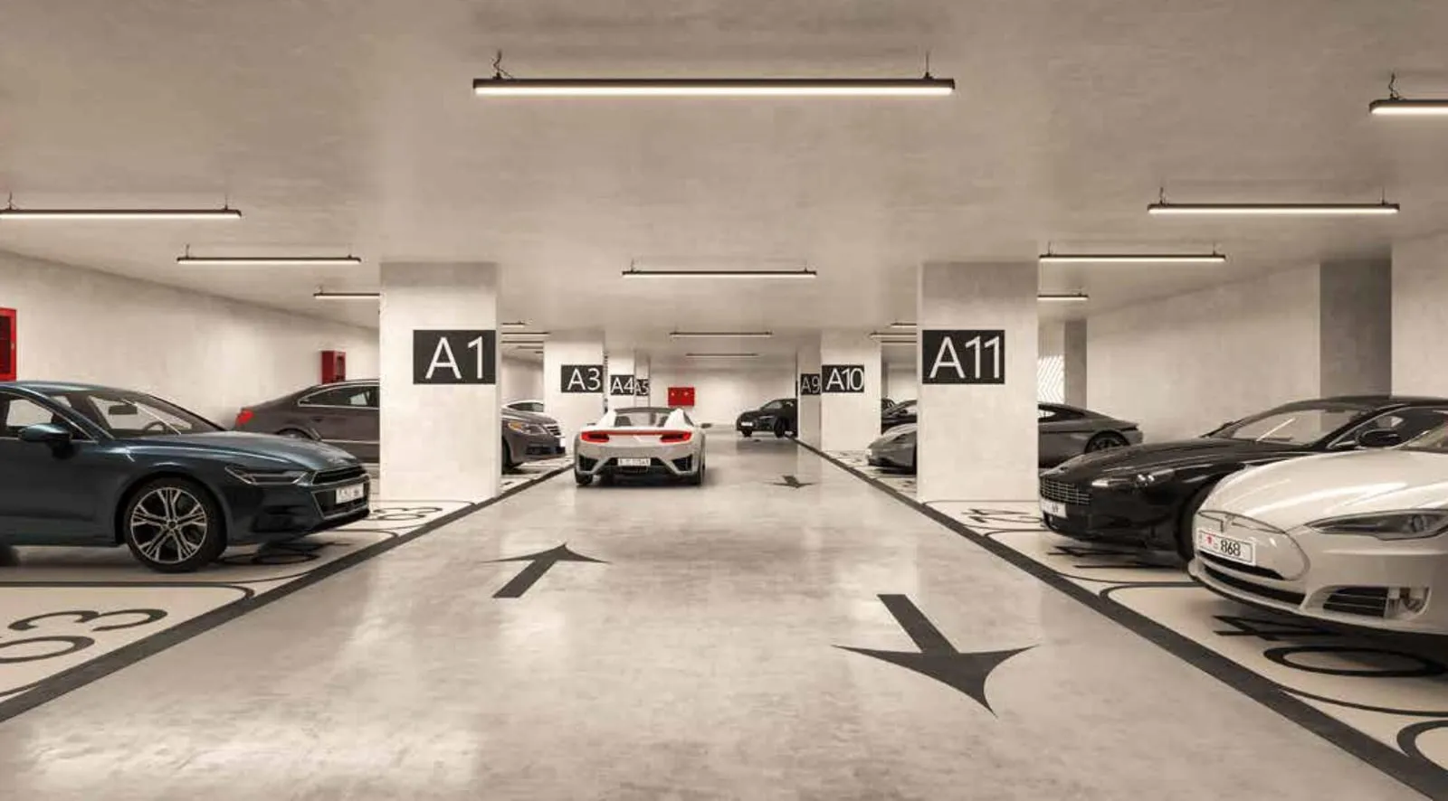 The covered parking level, numbered bays and directional arrows painted on the floor between parked cars