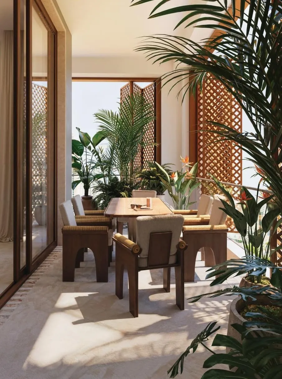 A dining corner beside full height glass, four dark chairs around the table and palms in the foreground
