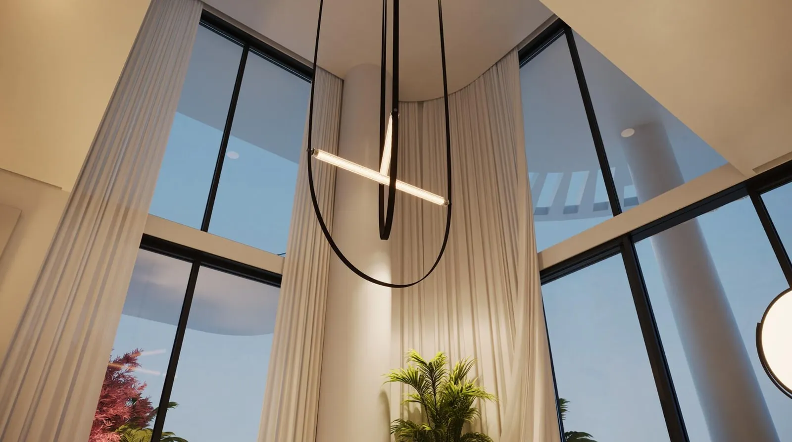 A double-height window wall in a duplex, a long pendant hanging beside floor-to-ceiling drapes and bougainvillea outside