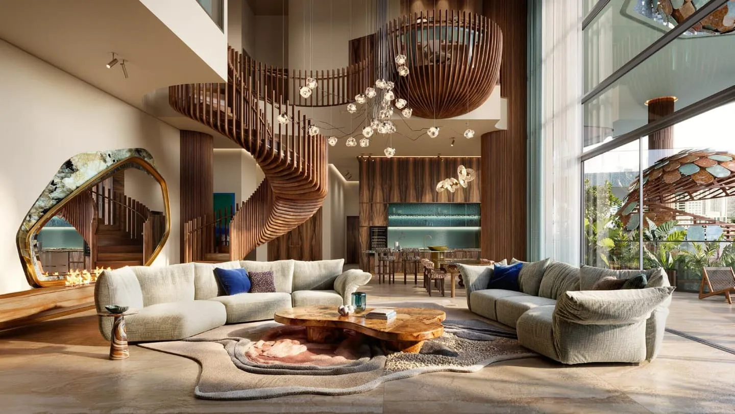 A double height living room, a sculptural staircase curving to the floor above and pale sofas set below it