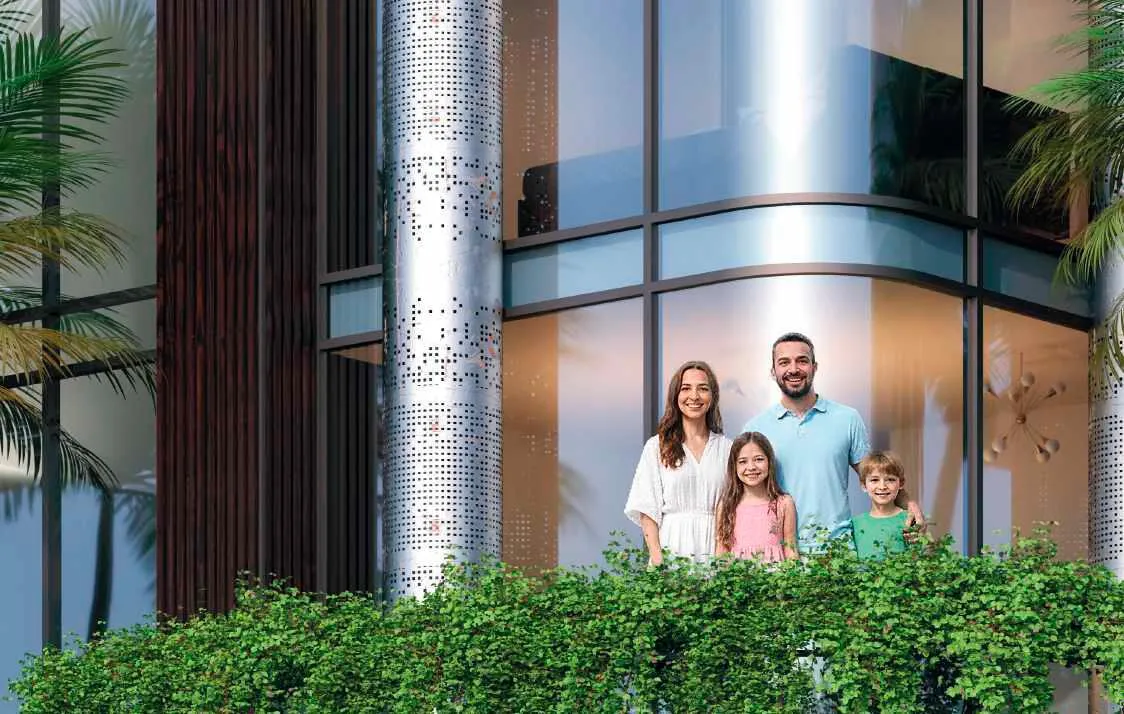 A family outside the glazed ground floor, clipped hedging and a stone column at the entrance