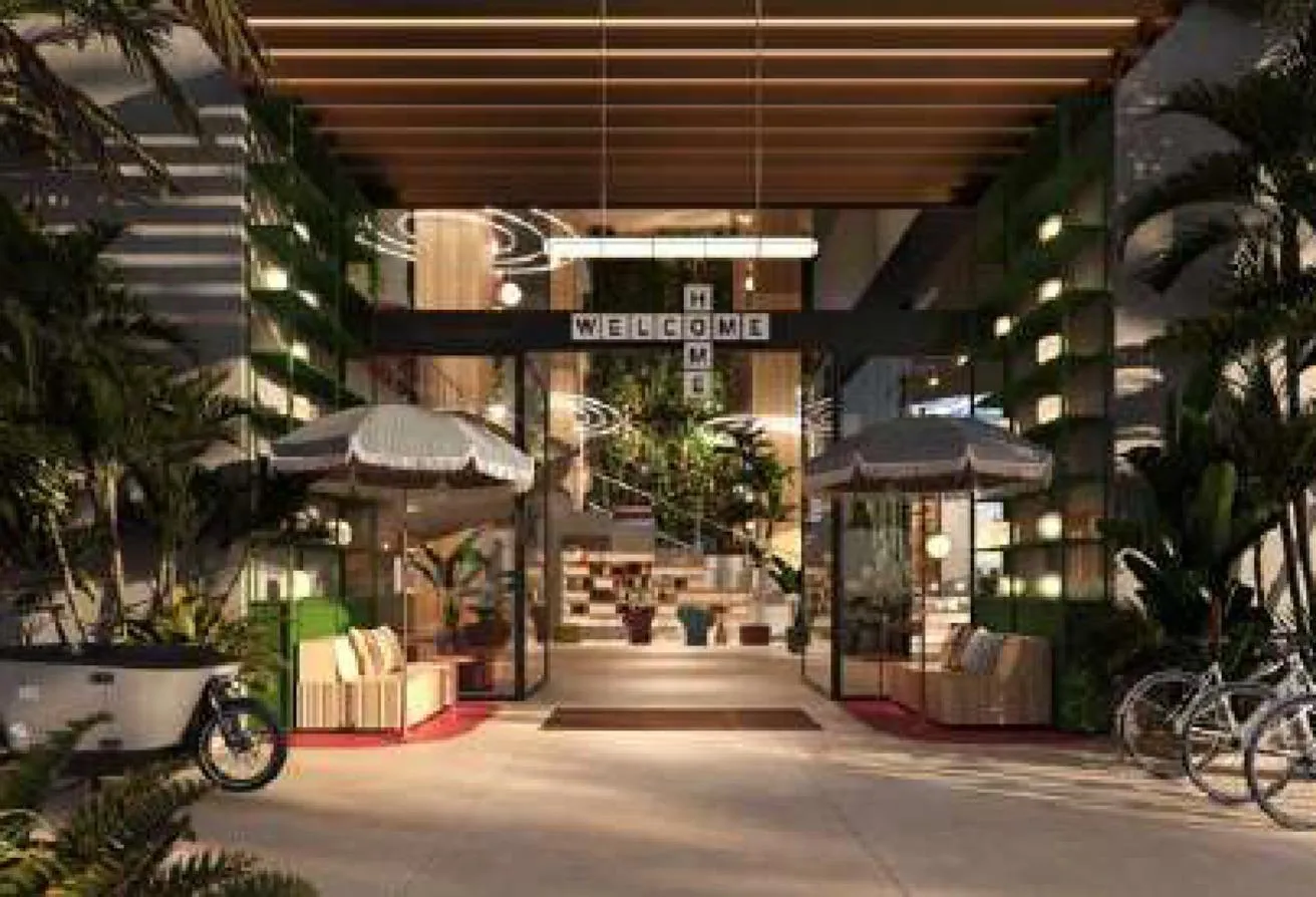 Render of the entrance, with a Welcome sign above planted walls and parked bicycles