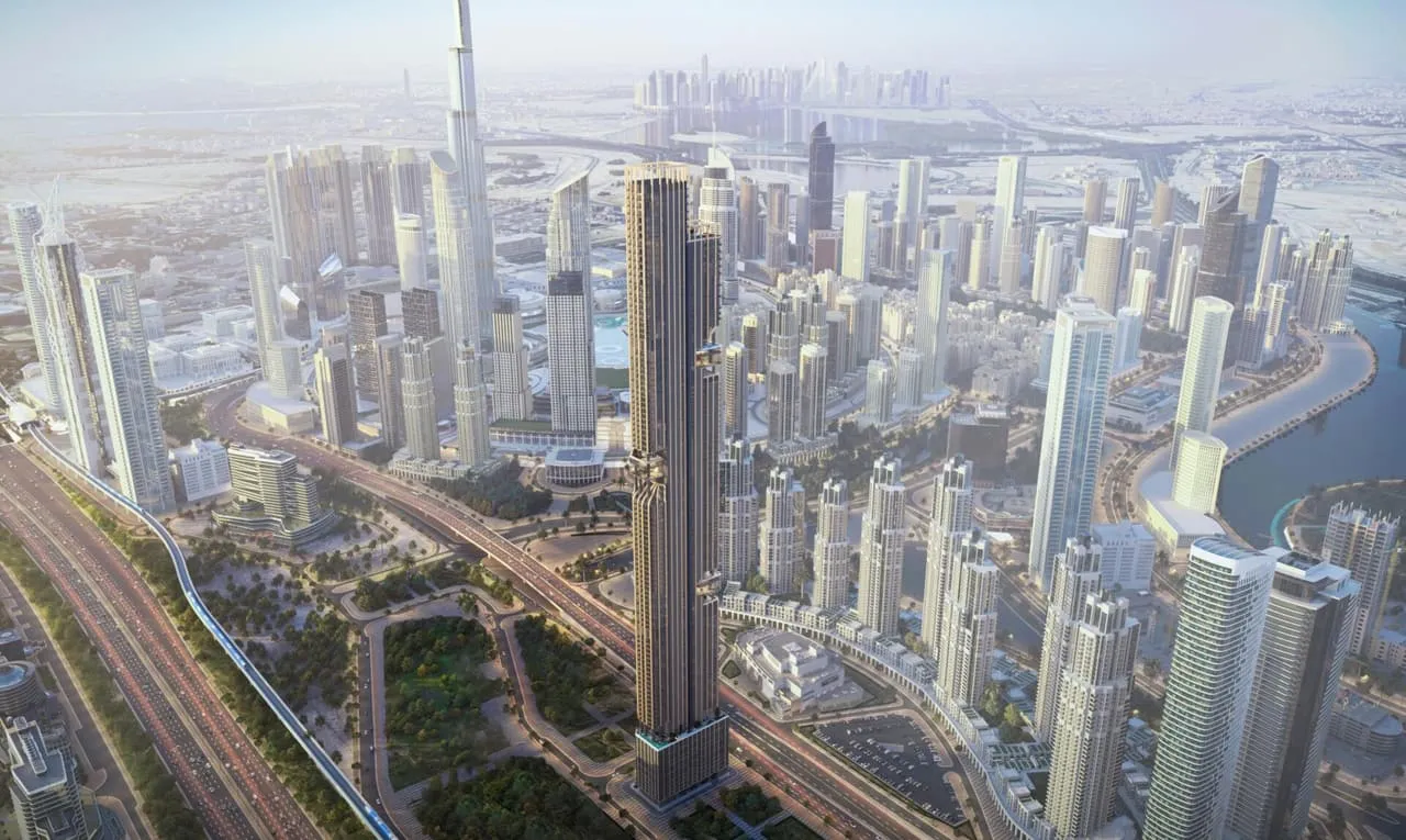 The tower from the air with Burj Khalifa behind it, the canal running past its base