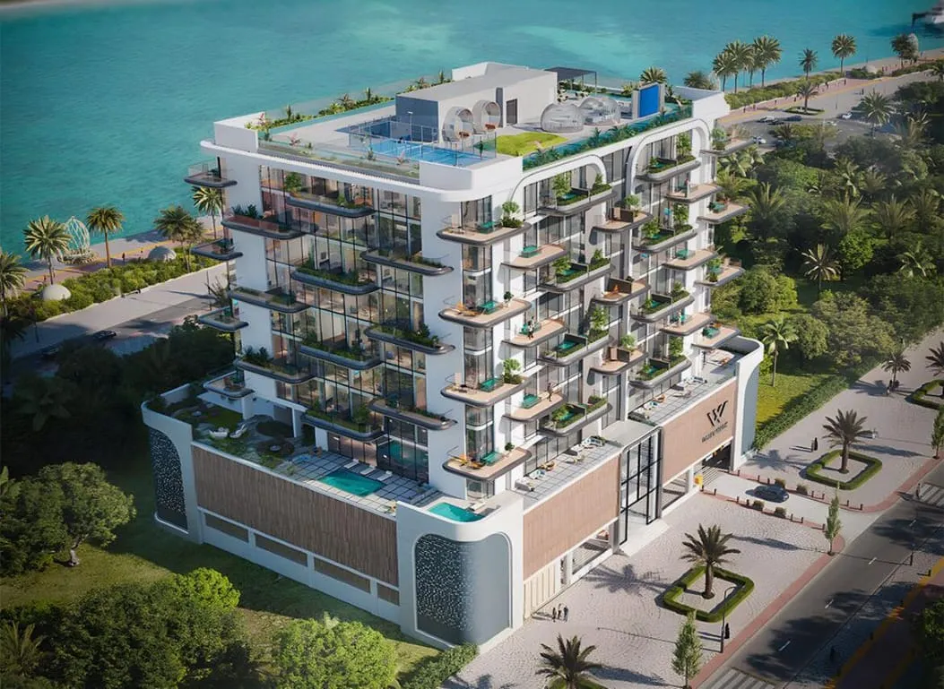 An aerial view of the building rising from a landscaped pool deck, the sea visible beyond the palms