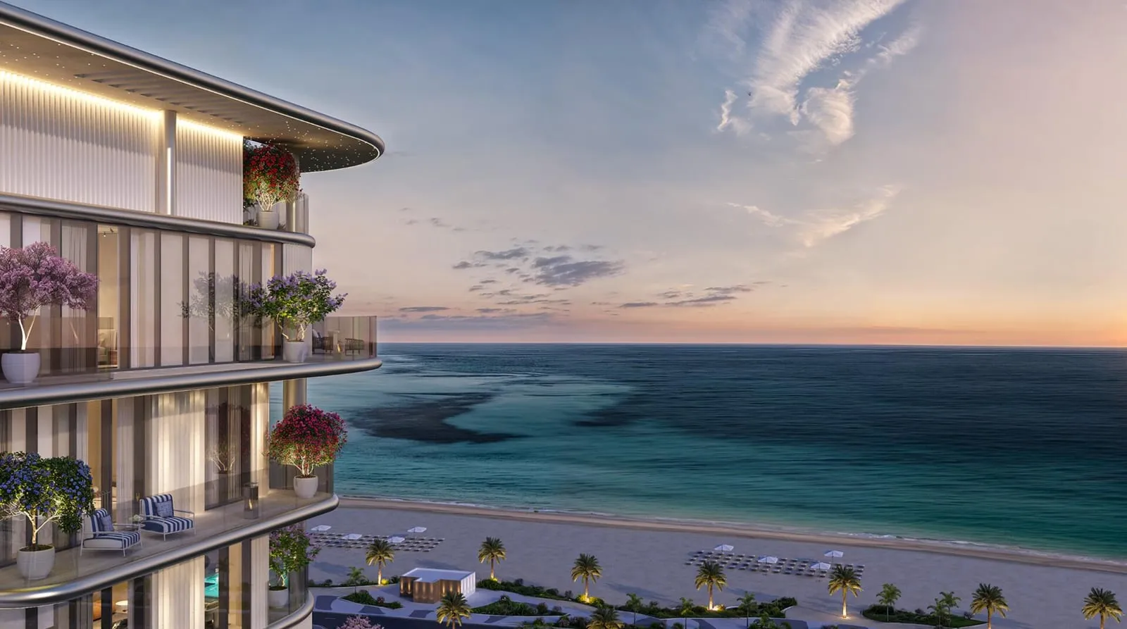 The building seen from the beach at sunset, its terraces looking out over the turquoise shallows