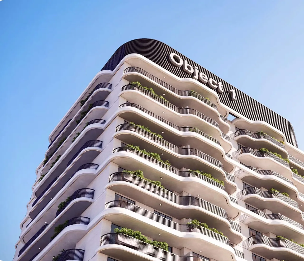 The crown of the building against a clear sky, the developer's name set on the parapet