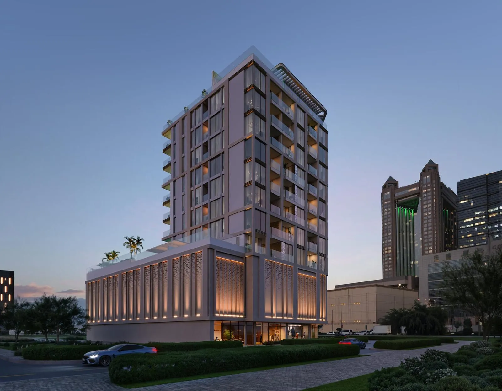 The same corner at dusk, the vertical fins of the podium lit warm below the balconies and an office tower behind on the right