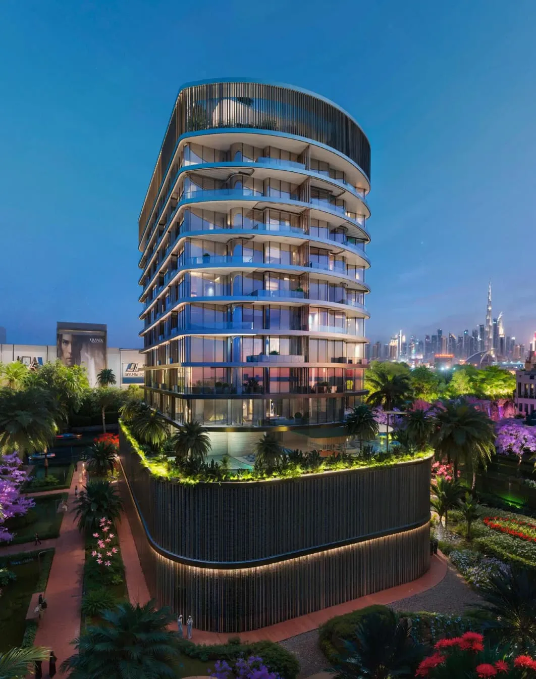 A residential tower at dusk above a lit garden
