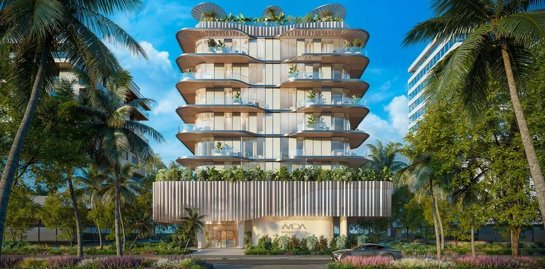 Avida Residences in daylight, its stacked curved balconies planted with greenery and framed by palm trees