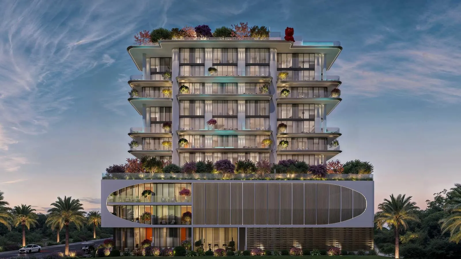 The building head-on at golden hour, planted balcony bands stacked above a curved podium with palms in front