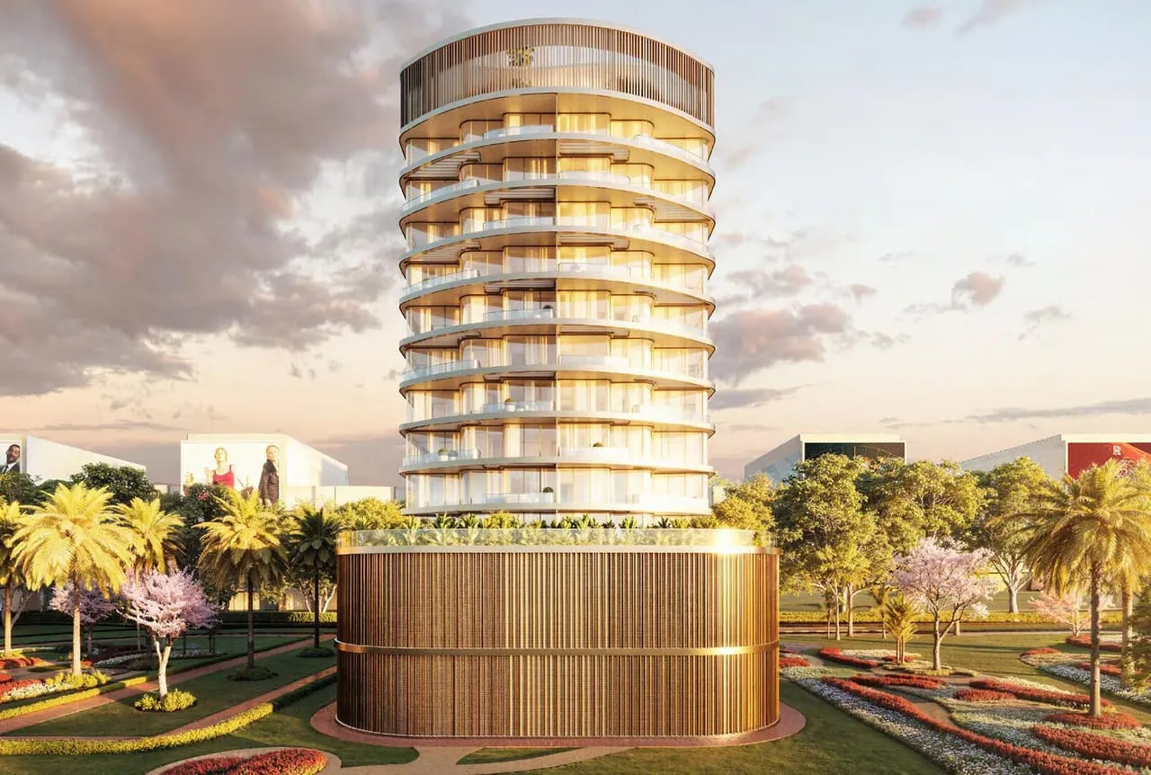 The building at sunset from the gardens, the podium wrapped in bronze fins with planting along its rim