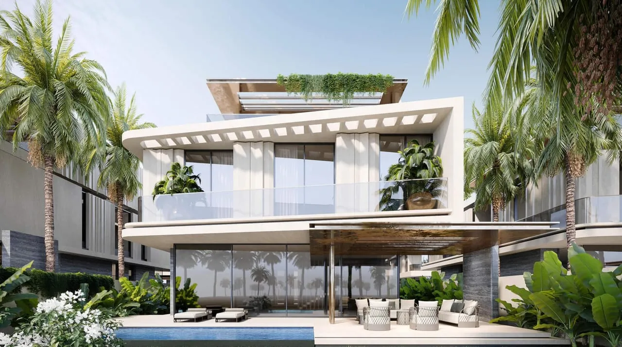 A Bentley Home villa seen across the crystal lagoon, sun loungers along the water's edge