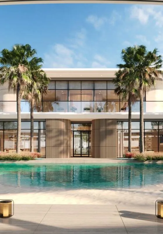 A Karl Lagerfeld villa reflected in the turquoise water of its pool, palms along the edge