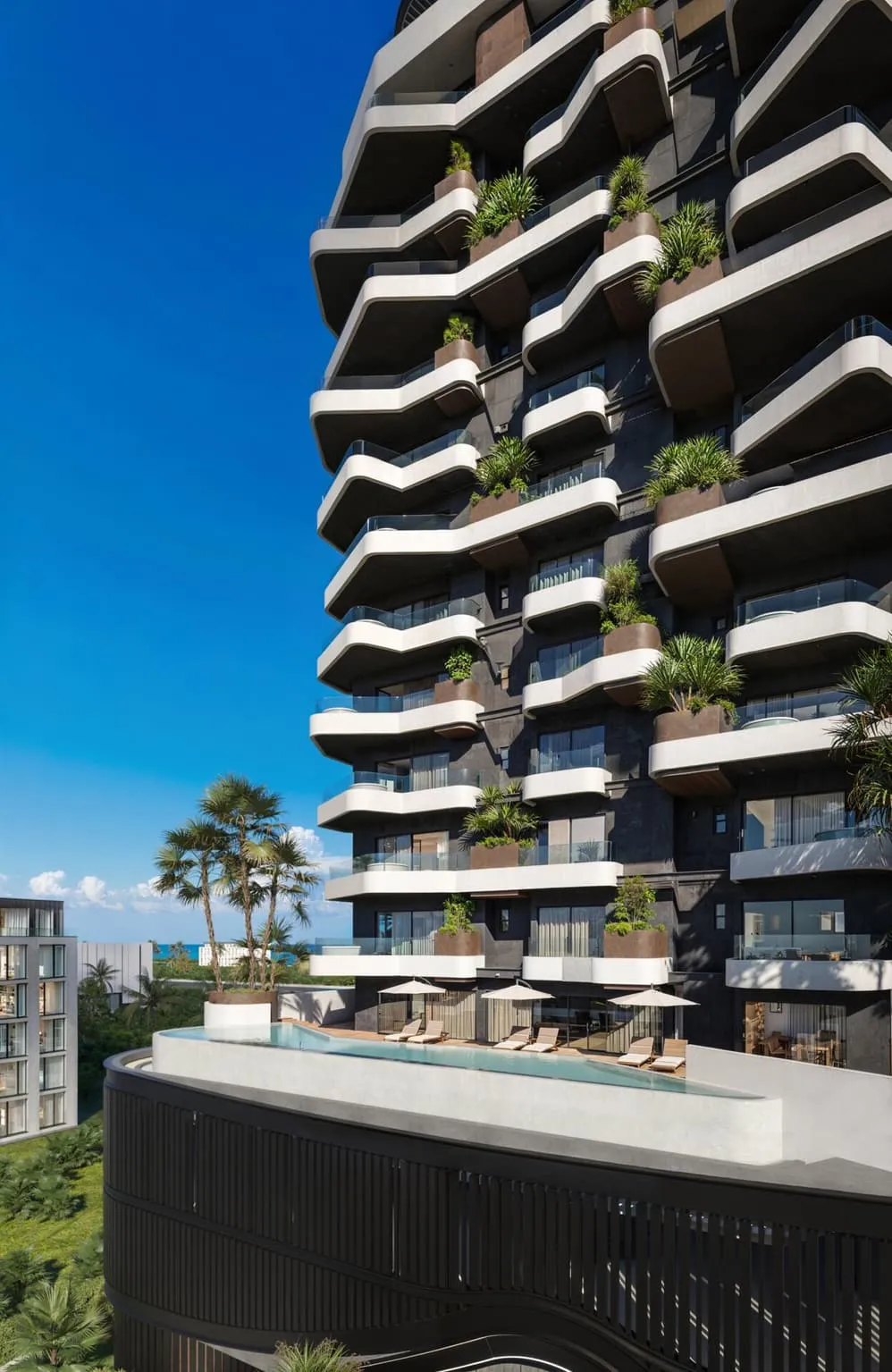 The tower seen from the pool deck, palm trees framing the sculpted white balconies against a clear sky