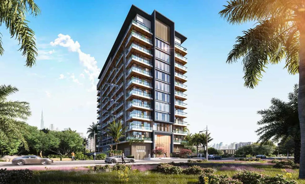 Aum 99 Residences seen from the street, its stepped balconies and charcoal-framed facade rising behind palm trees under a clear sky