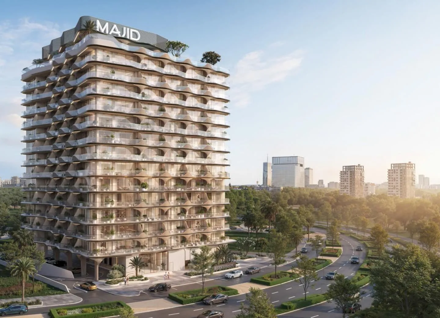 The tower from across the road, balcony slabs curving around every floor with planting along their edges and the developer's name lit on the roof