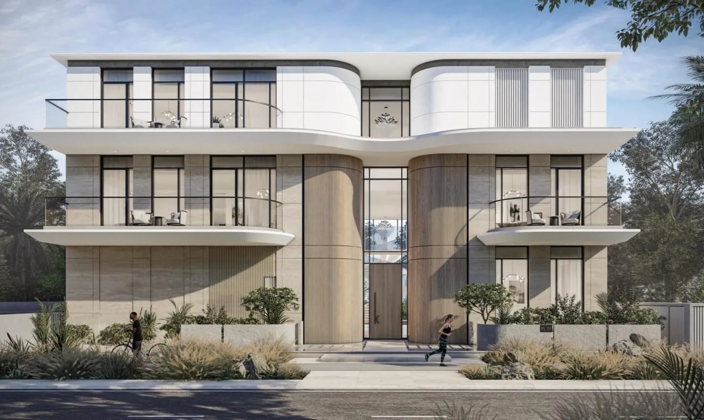 The street elevation of the Karl Lagerfeld villas, curved white forms above desert planting
