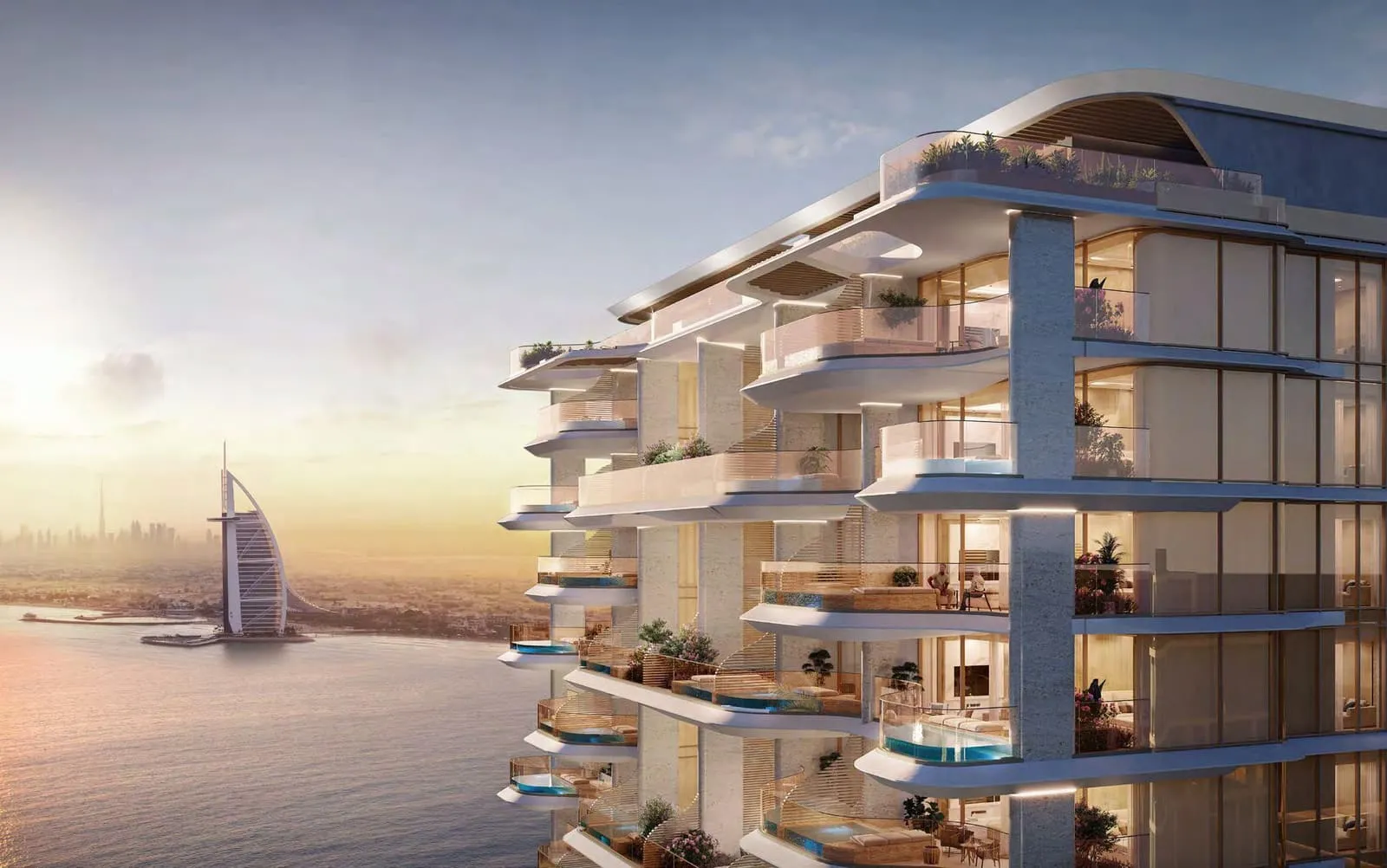 The building at sunset from the water, Burj Al Arab on the horizon behind it