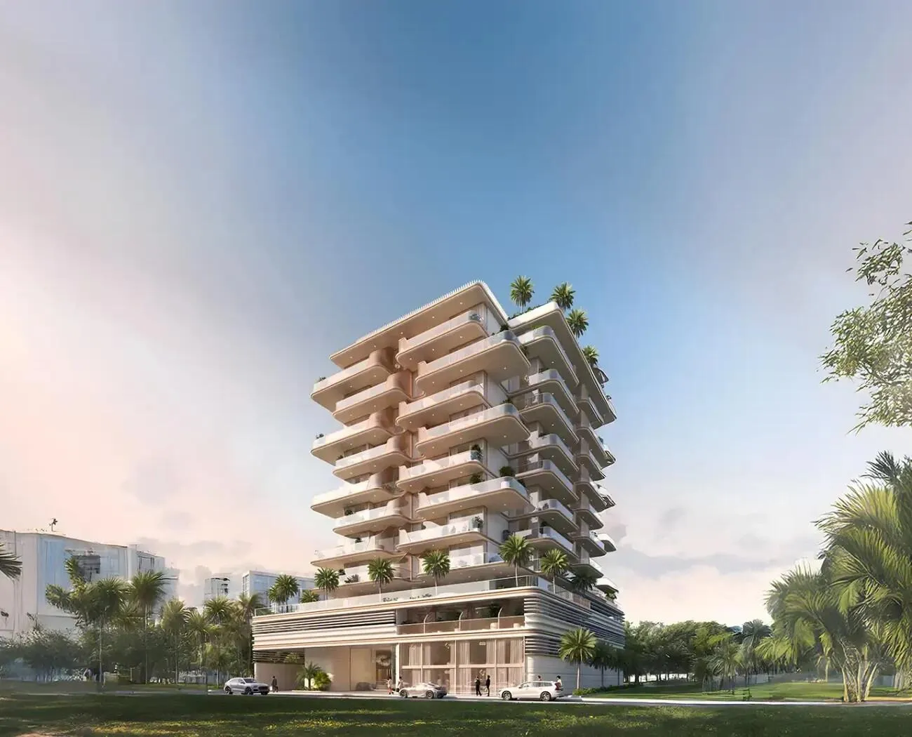 The whole building against a pink evening sky, its stacked terraces stepping back above a lawn and low planting